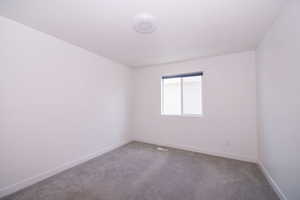 Empty room with carpet flooring and baseboards