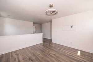 Unfurnished room with dark wood-style floors, a textured ceiling, and ceiling fan