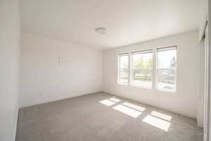 Spare room with light colored carpet