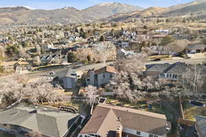 Aerial view of property's location featuring mountains and nearby suburban area