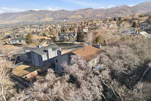 Aerial overview of property's location with a mountain backdrop and nearby suburban area