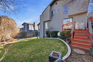 View of yard featuring stairs and a wooden deck