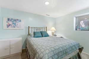 Carpeted bedroom featuring baseboards