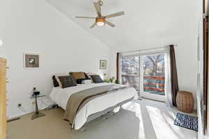 Bedroom with carpet flooring, ceiling fan, and lofted ceiling