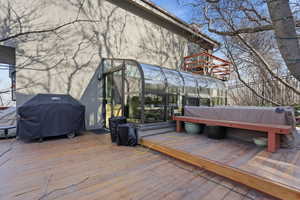 Wooden terrace featuring area for grilling