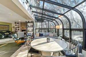 Sunroom featuring an outdoor living / dining area