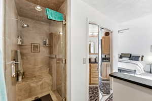 Bathroom featuring vanity and a stall shower