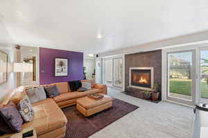 Living room featuring carpet floors and a tiled fireplace