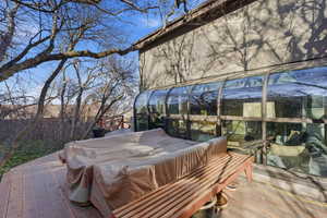 Wooden terrace featuring a sunroom