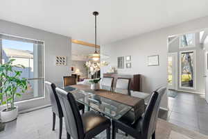 Dining area with light tile patterned flooring