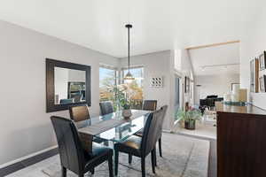 Dining area featuring baseboards and rail lighting