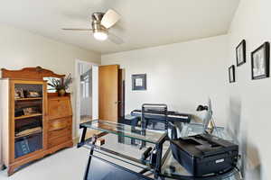 Office featuring light colored carpet and a ceiling fan