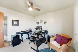 Carpeted office space with ceiling fan
