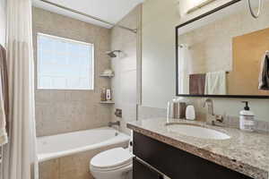 Bathroom with vanity and tiled shower / bath
