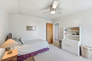 Bedroom featuring light carpet and a ceiling fan