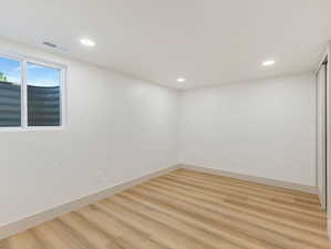 Spare room with light wood finished floors and recessed lighting