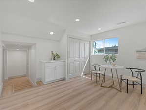 Living area featuring recessed lighting and light wood-style floors