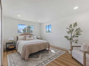 Bedroom with wood finished floors and recessed lighting