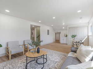 Living room featuring light wood-style flooring and recessed lighting