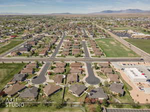 Aerial view of property's location featuring nearby suburban area and a mountainous background
