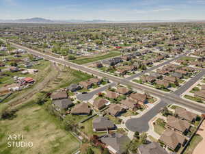 Aerial view of property's location with nearby suburban area and a mountainous background