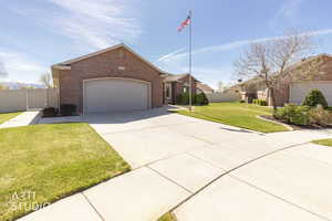 Traditional home featuring a gate, an attached garage, concrete driveway, and brick