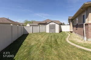Fenced backyard showing equipment shed