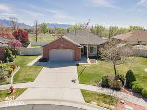 Elevated view of front of property showing front yard and fenced back yard.