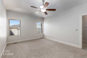 Unfurnished master bedroom featuring light colored carpet and a ceiling fan