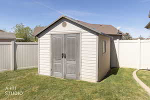 View of shed featuring a fenced backyard
