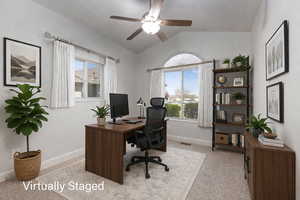Home office featuring vaulted ceiling, a ceiling fan, and light colored carpet (Virtually Staged)