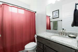 Bathroom featuring vanity and toilet