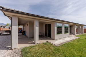 Back of house featuring a patio area and stucco siding
