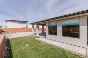Fenced backyard with a patio