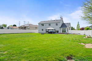 Back of property featuring a gazebo, a fenced backyard, and a patio area