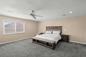 Bedroom with dark carpet, a ceiling fan, and recessed lighting