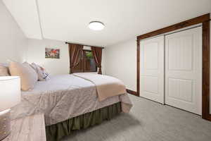 Bedroom featuring light colored carpet and a closet