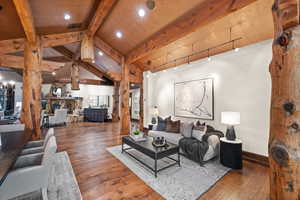 Living room with hardwood / wood-style floors, recessed lighting, and a fireplace