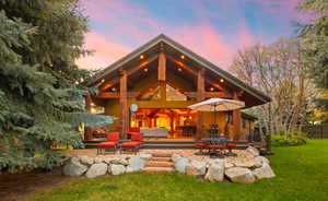 Back of property featuring an outdoor living / dining area and a patio