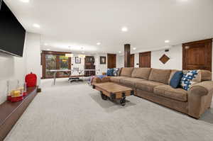 Living room with recessed lighting and light carpet