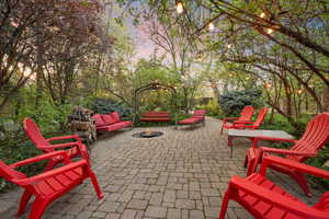 Patio terrace at dusk featuring an outdoor fire pit and a patio area