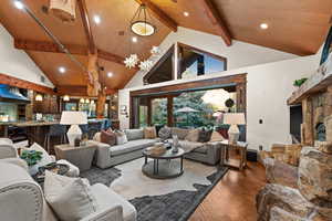 Living area featuring recessed lighting, wood finished floors, a stone fireplace, and french doors