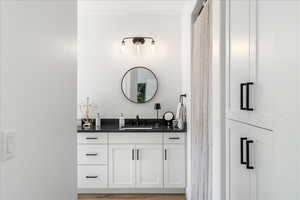 Bathroom with vanity and light wood-type flooring
