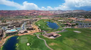 Aerial view of residential area featuring a water and mountain view and a golf course