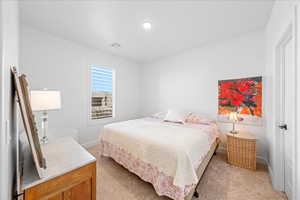 Bedroom featuring baseboards and light colored carpet