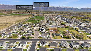 Aerial overview of property's location with nearby suburban area and a mountain backdrop
