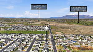 Aerial perspective of suburban area with a mountain backdrop