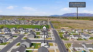 Aerial view of residential area featuring a mountainous background