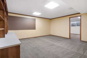 Unfurnished room featuring light colored carpet and ornamental molding