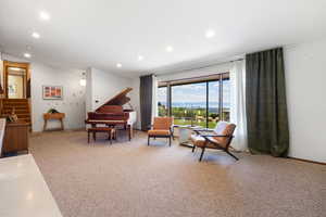 Living area with a mountain view, recessed lighting, and light colored carpet